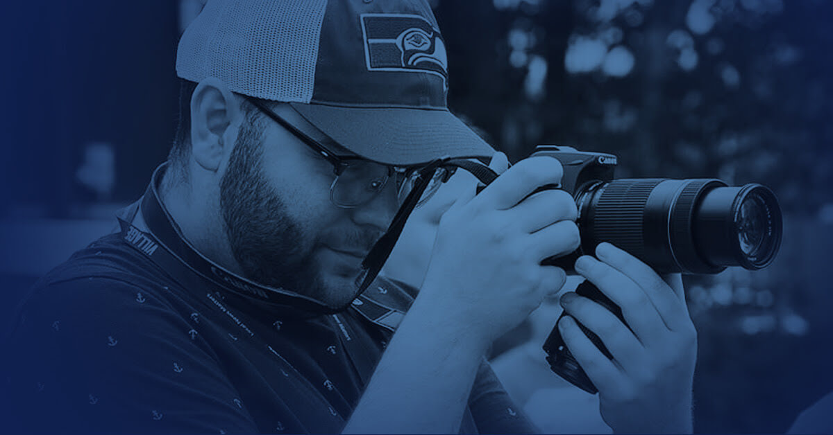 Alex Flood snapping a photo on his camera