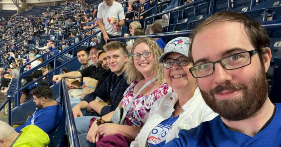 Village employees taking a group selfie at the Blue Jays game