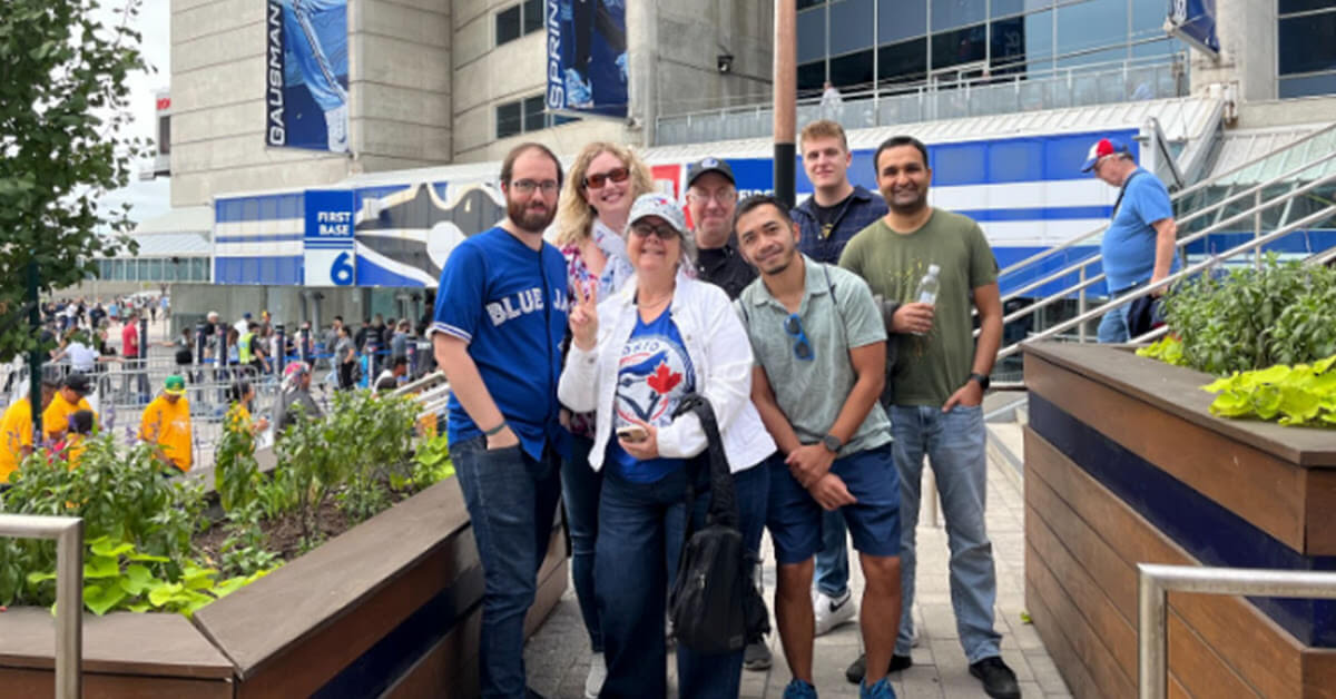 Group photo of Village Media employees outside of the Rogers Centre